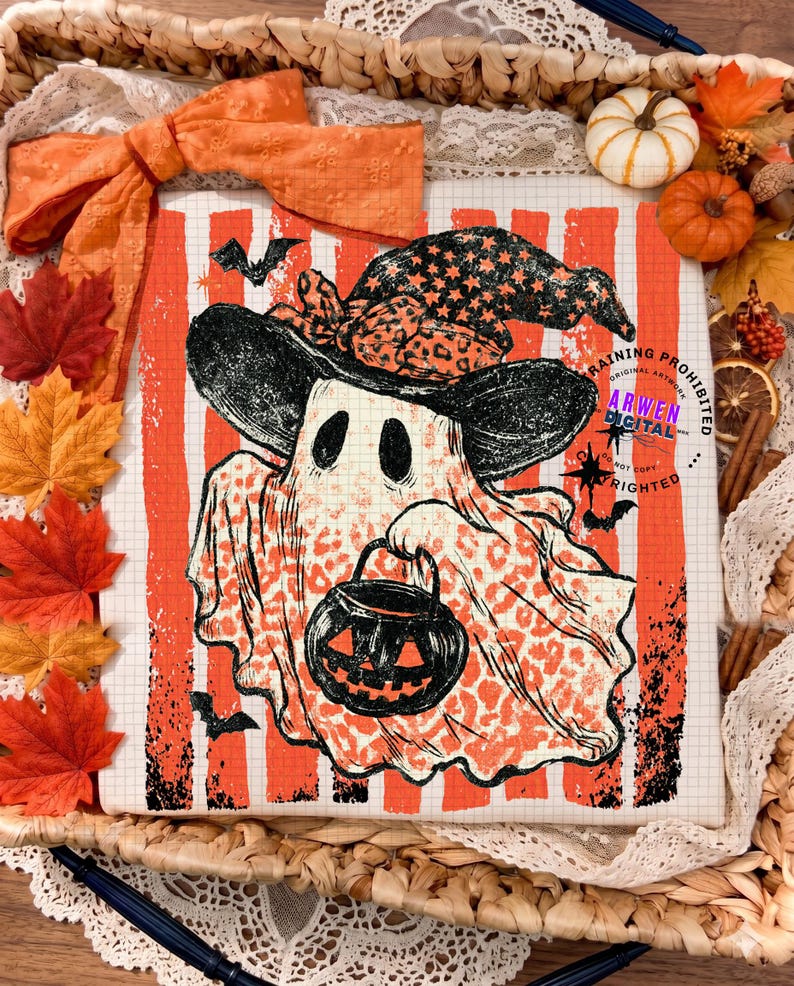 May include: A white t-shirt featuring a graphic of a ghost wearing a witch hat and holding a jack-o'-lantern bucket. The ghost has a leopard print pattern, set against a background of vertical orange stripes and a grid pattern with small bats.