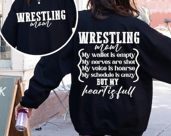 May include: Black sweatshirt with white text that reads "WRESTLING mom My wallet is empty My nerves are shot My voice is hoarse My schedule is crazy BUT MY heart is full"
