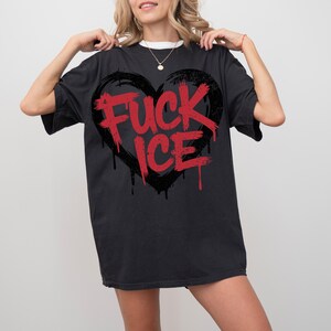 May include: Black t-shirt with a large black heart graphic and the words "FUCK ICE" in red. The design has a distressed, graffiti-style aesthetic. The shirt is a casual, oversized fit.