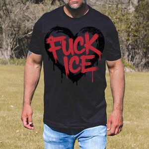 May include: Black t-shirt with a distressed black heart graphic and the red text "FUCK ICE". The text has a dripping effect. The shirt is made of a soft material.