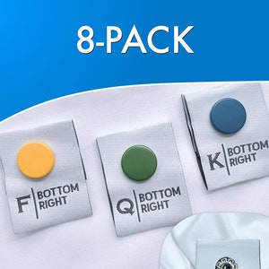May include: Eight-pack of bed corner labels with different colored dots and letters. The labels say "Bottom Right" and have the letters F, Q, K. One label says "Bed Corner Labels".