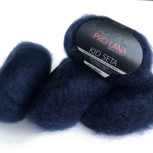May include: Two balls of dark blue yarn labelled "Meine Wolle Pro Lana Kid Seta" with the text "Mischung mit feinstem Super Kid Mohair 70% Mohair / mohair 30% Seide / silk 25g ca. 210m"