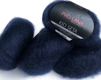 May include: Two skeins of dark blue yarn labeled "Meine Wolle Pro Lana Kid Seta" with the text "Mischung mit feinstem Super Kid Mohair 70% Mohair / mohair 30% Seide / silk 25g ca. 210m"