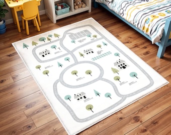 May include: A rectangular off-white play rug with a road map design. The rug features gray roads, green trees, blue trees, and small houses. The rug is designed for children's playrooms and bedrooms.