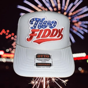 May include: A white trucker hat featuring an embroidered patch on the front with the text Two Fiddy in blue with white stars and red lettering. A rectangular sticker on the brim displays the Otto brand logo and product details in black text.