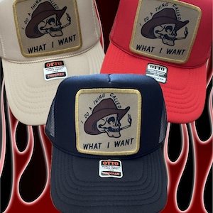 May include: Three trucker hats with a skull wearing a cowboy hat and smoking a cigarette. The patch on the front of the hats says "I do a thing called what I want".