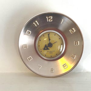 May include: A set of three ceramic mugs with a speckled, matte finish. The mugs are in shades of cream, light gray, and dark gray. Each mug has a simple, minimalist design, perfect for coffee or tea.