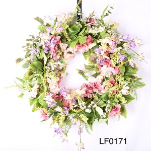 May include: A spring wreath with pink, purple, and white flowers and green leaves. The wreath is decorated with small, delicate flowers and has a rustic, natural look. The wreath is labeled "LF0171".