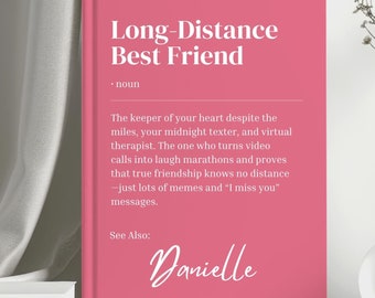May include: A pink book with the title "Long-Distance Best Friend" and a definition of the term. The book also includes the name "Danielle" in pink cursive writing.