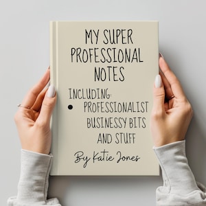 May include: A beige notebook with the text "MY SUPER PROFESSIONAL NOTES INCLUDING: PROFESSIONALIST BUSINESSY BITS AND STUFF By Katie Jones" written in black.