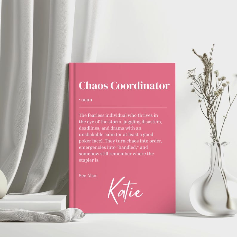 May include: Pink printable card with the text "Chaos Coordinator" defined as "The fearless individual who thrives in the eye of the storm, juggling disasters, deadlines, and drama with an unshakable calm (or at least a good poker face). They turn chaos into order, emergencies into 'handled,' and somehow still remember where the stapler is."  The card also includes the text "See Also: Katie".
