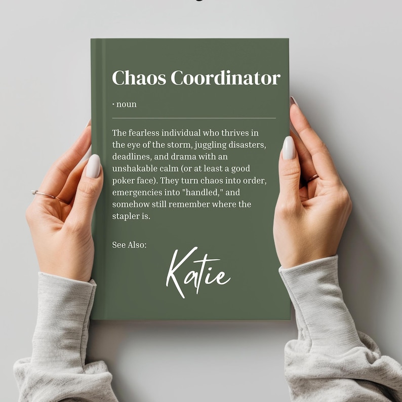 May include: A green book with the text "Chaos Coordinator" and a definition of the term. The book also includes the name "Katie" written in cursive.