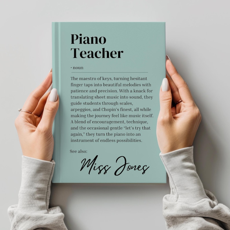 May include: A teal blue book with the title "Piano Teacher" and the text "The maestro of keys, turning hesitant finger taps into beautiful melodies with patience and precision. With a knack for translating sheet music into sound, they guide students through scales, arpeggios, and Chopin's finest, all while making the journey feel like music itself. A blend of encouragement, technique, and the occasional gentle 'let's try that again,' they turn the piano into an instrument of endless possibilities. See also: Miss Jones"