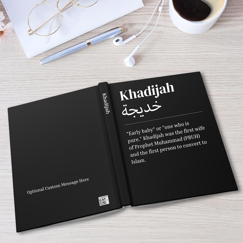 May include: Black book with the word "Khadijah" written in white on the cover. The book also includes the Arabic word for Khadijah and a definition of the name. The definition reads "Early baby" or "one who is pure." Khadijah was the first wife of Prophet Muhammad (PBUH) and the first person to convert to Islam.