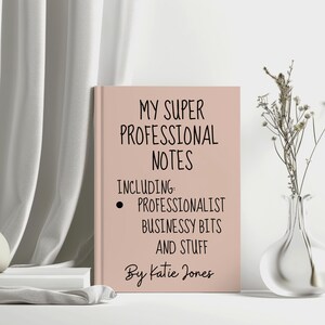 May include: A pink notebook with the title "My Super Professional Notes" and the text "Including: Professionalist Businessy Bits and Stuff" and "By Katie Jones".