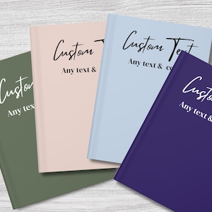 May include: Four hardcover journals with different coloured covers. The covers are green, pink, light blue, and purple. Each cover has the text "Custom Text" and "Any text & co" written in black.