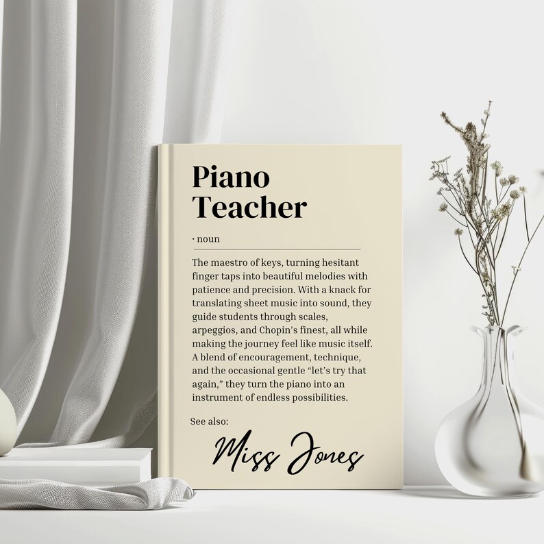 May include: A beige printable wall art print with a black and white definition of a piano teacher. The text reads "The maestro of keys, turning hesitant finger taps into beautiful melodies with patience and precision. With a knack for translating sheet music into sound, they guide students through scales, arpeggios, and Chopin's finest, all while making the journey feel like music itself. A blend of encouragement, technique, and the occasional gentle 'let's try that again,' they turn the piano into an instrument of endless possibilities." The text "See also:" is followed by the name "Miss Jones" in cursive.
