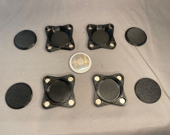 May include: Six black round and square magnetic bases for a 1 inch button pin. The bases are made of plastic and have a textured surface. One white button pin with a silver metal center is also included.