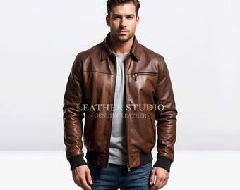 May include: A brown leather jacket with a zipper closure and a stand-up collar. The jacket has a logo that says "LEATHER STUDIO - GENUINE LEATHER".