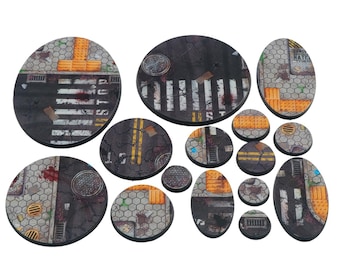 May include: A collection of miniature bases with a street theme. The bases are various shapes and sizes, featuring crosswalks, manhole covers, and road markings. The color palette includes gray, black, yellow, and orange.