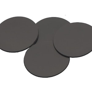 May include: Four black round felt pads, likely for furniture or other objects, to prevent scratching.
