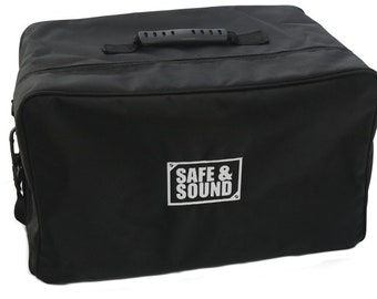 May include: Black padded carrying case with a top handle and a shoulder strap. The case has a white logo that says "SAFE & SOUND".