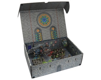 May include: An open box with a gray stone exterior and a stained glass window design. The interior of the box is filled with miniature figures and scenery, depicting a battle scene.