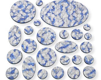 May include: A collection of decorative coasters in various shapes and sizes. The coasters feature a white background with blue and gray veining, creating a marble-like appearance. Each coaster has a black border.