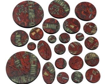 May include: A collection of red and green miniature bases in various shapes and sizes. The bases have a textured, weathered appearance with wooden planks and metal details. Ideal for tabletop gaming.