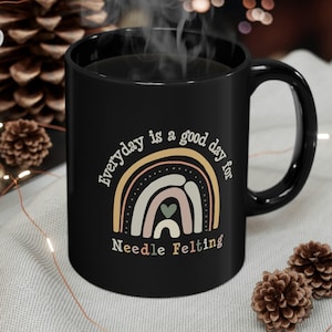 May include: Black coffee mug with a rainbow design and the text "Everyday is a good day for Needle Felting".
