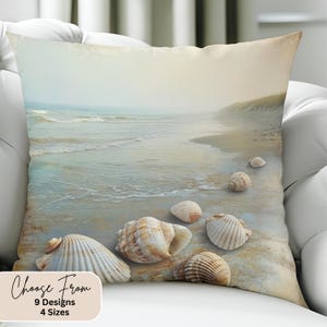 May include: A throw pillow with a beach scene featuring a sandy beach, ocean waves, and seashells. The text "Choose From 9 Designs 4 Sizes" is at the bottom of the pillow.