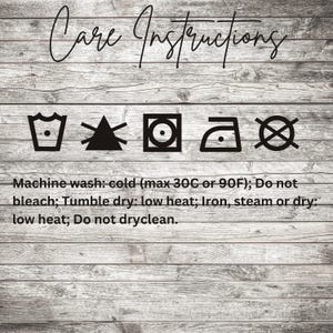 May include: Image of care instructions on a wooden background. The text reads: Machine wash cold (max 30C or 90F); Do not bleach; Tumble dry low heat; Iron, steam or dry low heat; Do not dryclean.