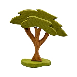 May include: A wooden toy tree with a brown trunk and green leaves. The tree is standing on a green base.