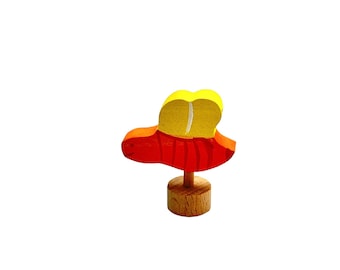 May include: A wooden toy bee with a red body and yellow wings. The bee is standing on a wooden base.