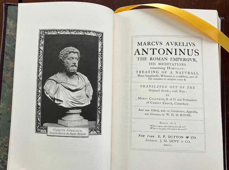 May include: A black and white image of a bust of Marcus Aurelius, a Roman emperor, from the Naples Museum. The image is from a book titled "Marcus Aurelius Antoninus, The Roman Emperor, His Meditations Concerning Himself: Treating of a Naturall Mans Happinesse; Wherein it Consists, and of the Meanes to Attaine unto it." The book was translated from the original Greek by Meric Casaubon, B. of D. and Prebendary of Christ Church, Canterbury. It was edited with an introduction, appendix, and glossary by W. H. D. Rouse. The book was published by E. P. Dutton & Co. in New York and J. M. Dent & Co. in London in 1900.