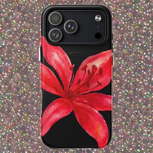 An iPhone case features a large red lily flower on a black background against a glittering backdrop.