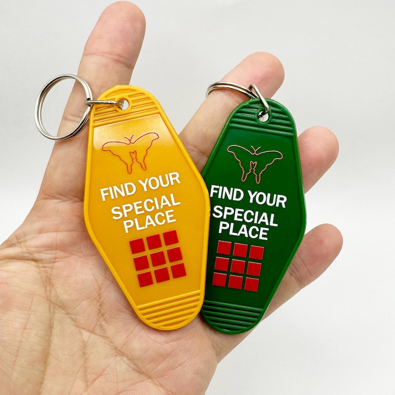 May include: Two yellow and green motel keychains with a butterfly design and the text "Find your special place".