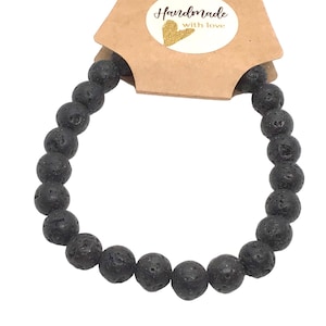 May include: Black lava rock beaded bracelet. The bracelet is made of small, round beads and is approximately 7 inches in length.