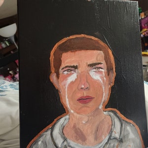 Crying boy painting