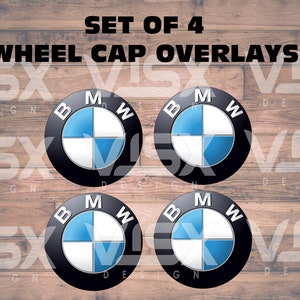 May include: Set of four black and white wheel cap overlays with a blue BMW logo. The overlays are designed to fit over existing wheel caps.