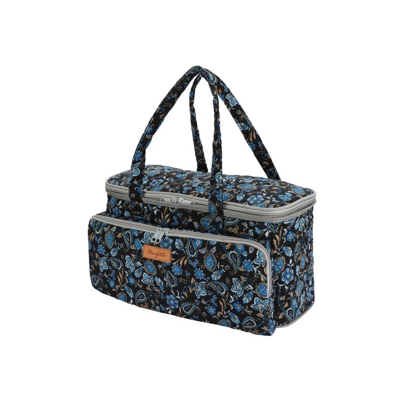 May include: A black and blue floral patterned insulated tote bag with two handles and a zipper closure. The bag has a brown leather patch with the word "Handmade" on it.