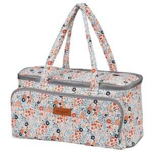 May include: A white fabric tote bag with a floral pattern in shades of orange, blue, and pink. The bag has two gray handles and a brown leather patch with the text "Honfeizhi" on the front.