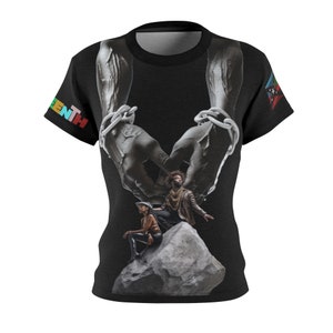 May include: Black t-shirt with a graphic of two hands holding a chain, and a couple on a rock below. The word "Juneteenth" is printed on the left sleeve. The shirt has a crew neck and short sleeves.