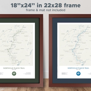 May include: Two framed prints, each 18" x 24", of the Northville Placid Trail map. One print has a green mat and the other has a blue mat. The frames are a dark brown color. The text "NORTHVILLE PLACID TRAIL" and "NIP" are visible.