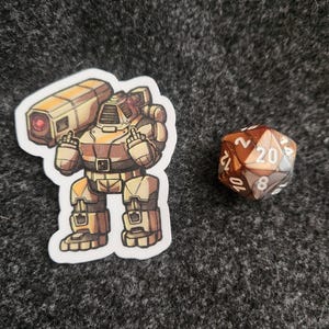 May include: A die-cut sticker featuring a tan and brown armored robot with a large shoulder-mounted cannon, shown giving the middle finger with both hands, positioned next to a twenty-sided die with brown and white marbled coloring and white numbers.