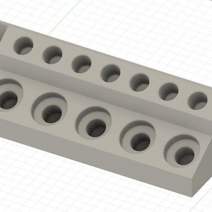 May include: Gray plastic organizer with 10 round holes for storing small items. The organizer has a slanted back and a flat front.