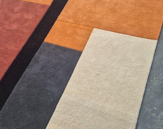 Tufted Rug, featuring a striking block-pattern design in warm earthy tones.