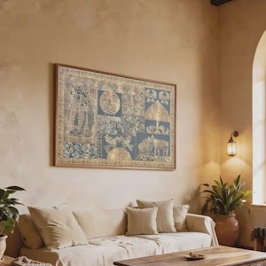 May include: A living room scene featuring a large framed artwork with a blue and gold design above a beige sofa with matching pillows. A wooden coffee table and side table are in front of the sofa. A potted plant and wall sconce add to the room's decor.