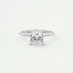 May include: A silver ring with a square-shaped diamond.