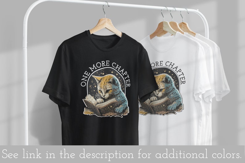 May include: Black and white t-shirt with a graphic of a cat reading a book. The graphic has a starry background and the text "One More Chapter".